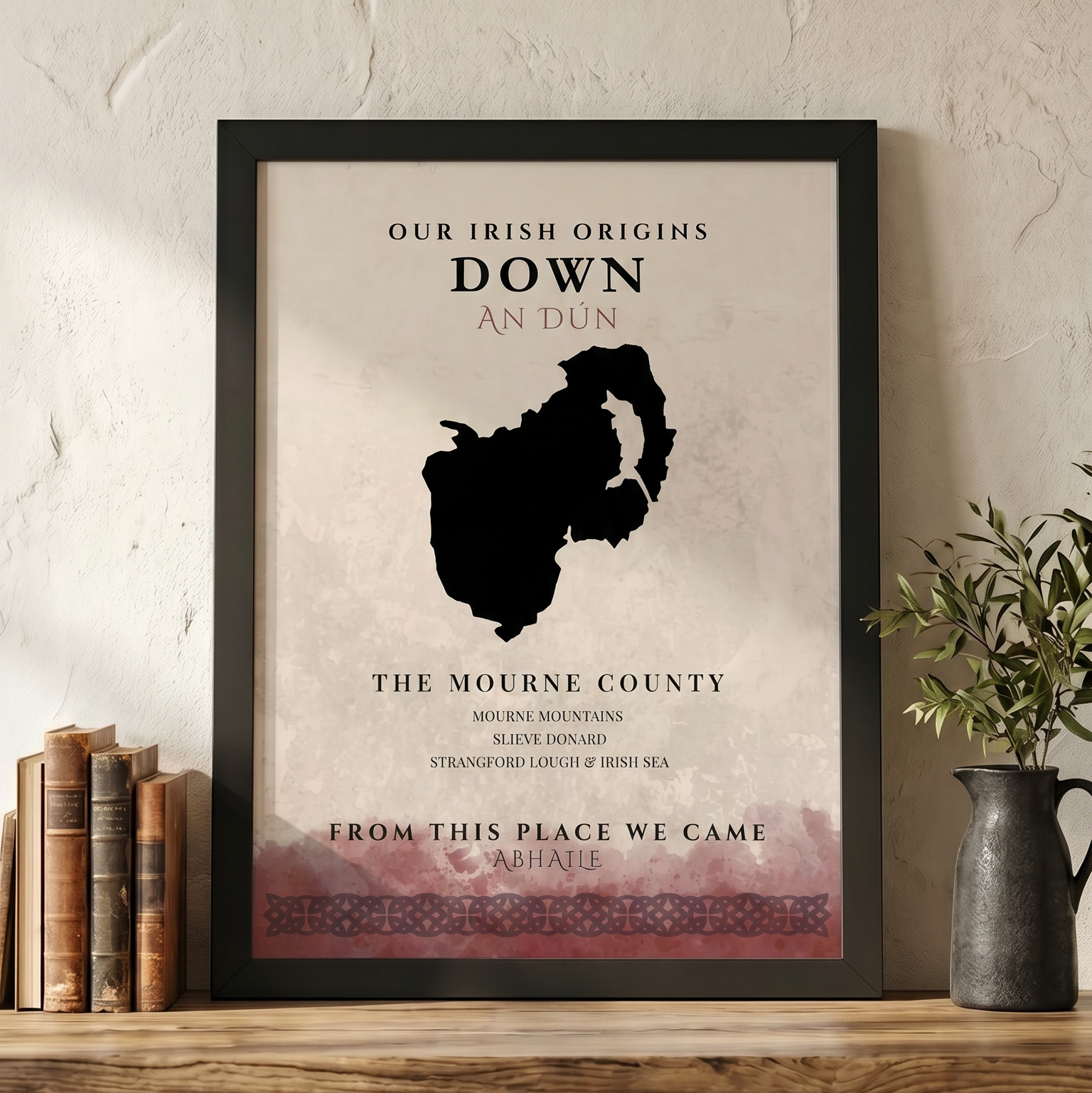 Framed poster of Mourne County with text on a wooden shelf.