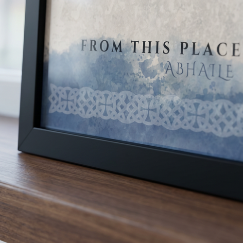 Framed artwork with text and decorative elements on a wooden surface